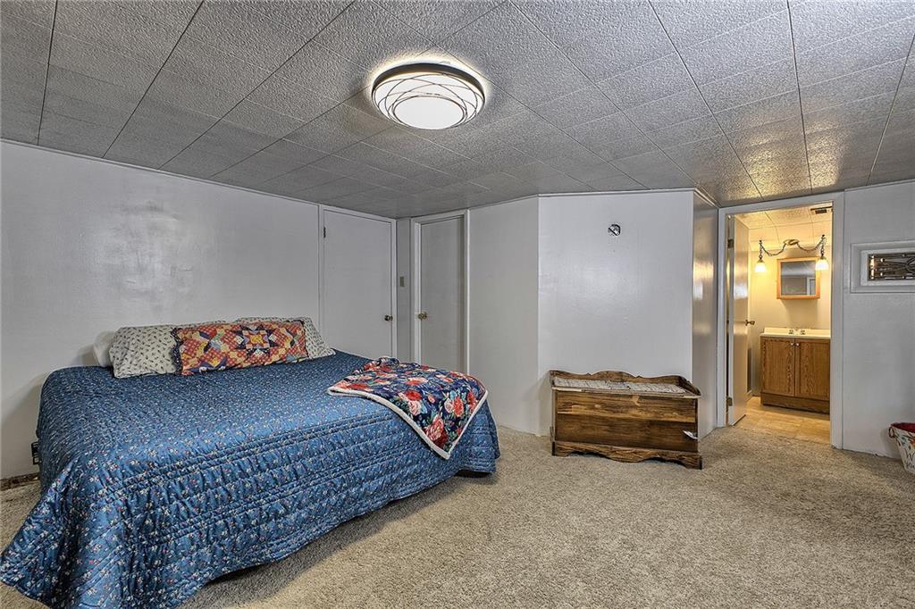 3456 Country Club Road Mount Pleasant, PA 15666 - Photo 38 of 39 a bedroom with a bed and a chandelier