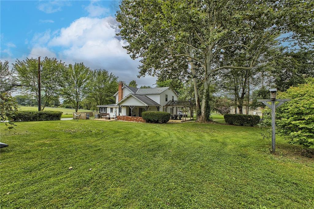3456 Country Club Road Mount Pleasant, PA 15666 - Photo 7 of 39 a view of a big house with a big yard and large trees