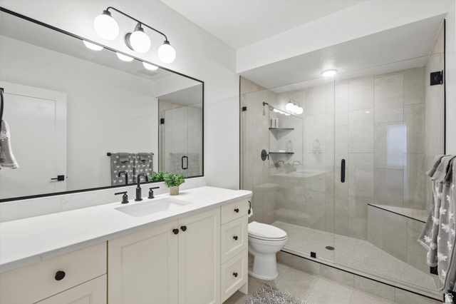 3349 Oxford Loop Morgan, UT 84050 - Photo 27 of 47 Full bath featuring vanity, a shower stall, and light tile patterned flooring