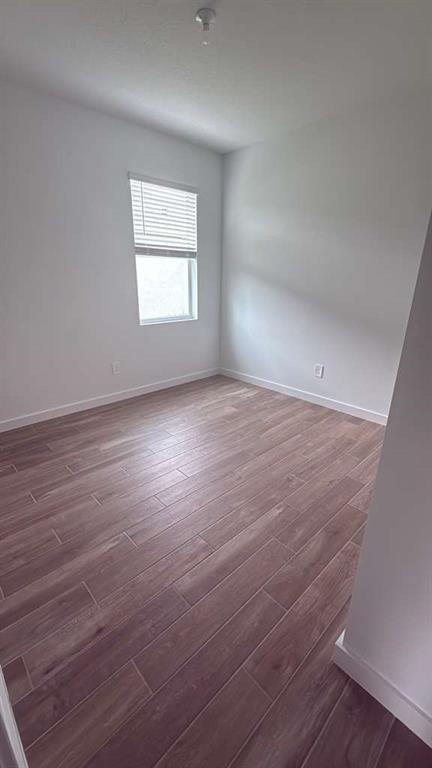 8780 Southwest Kanner Oaks Drive Stuart, FL 34997 - Photo 12 of 14 wooden floor in an empty room with a window