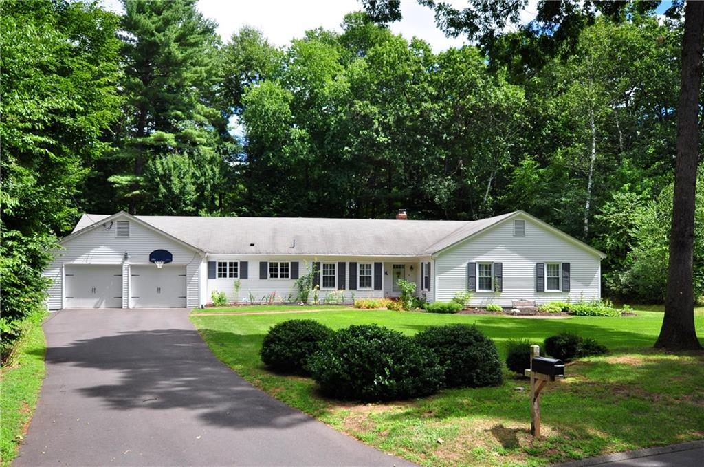 a view of house with garden and tall trees
