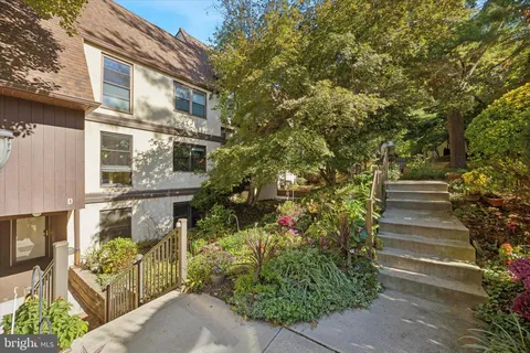 a front view of a house with plants