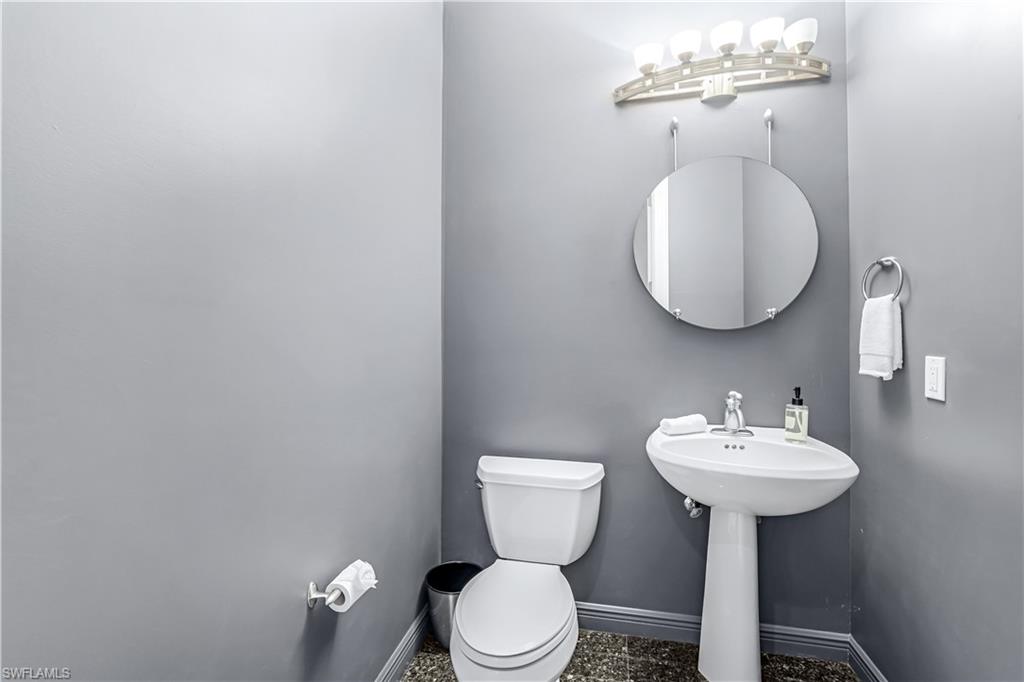 863 9th Avenue South, Unit 202 Naples, FL 34102 - Photo 27 of 35 a bathroom with a toilet sink and mirror