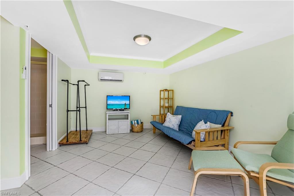 863 9th Avenue South, Unit 202 Naples, FL 34102 - Photo 35 of 35 a living room with furniture and a flat screen tv