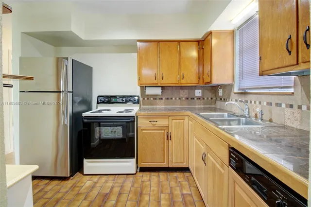 a view of a kitchen with a refrigerator and a cabinets