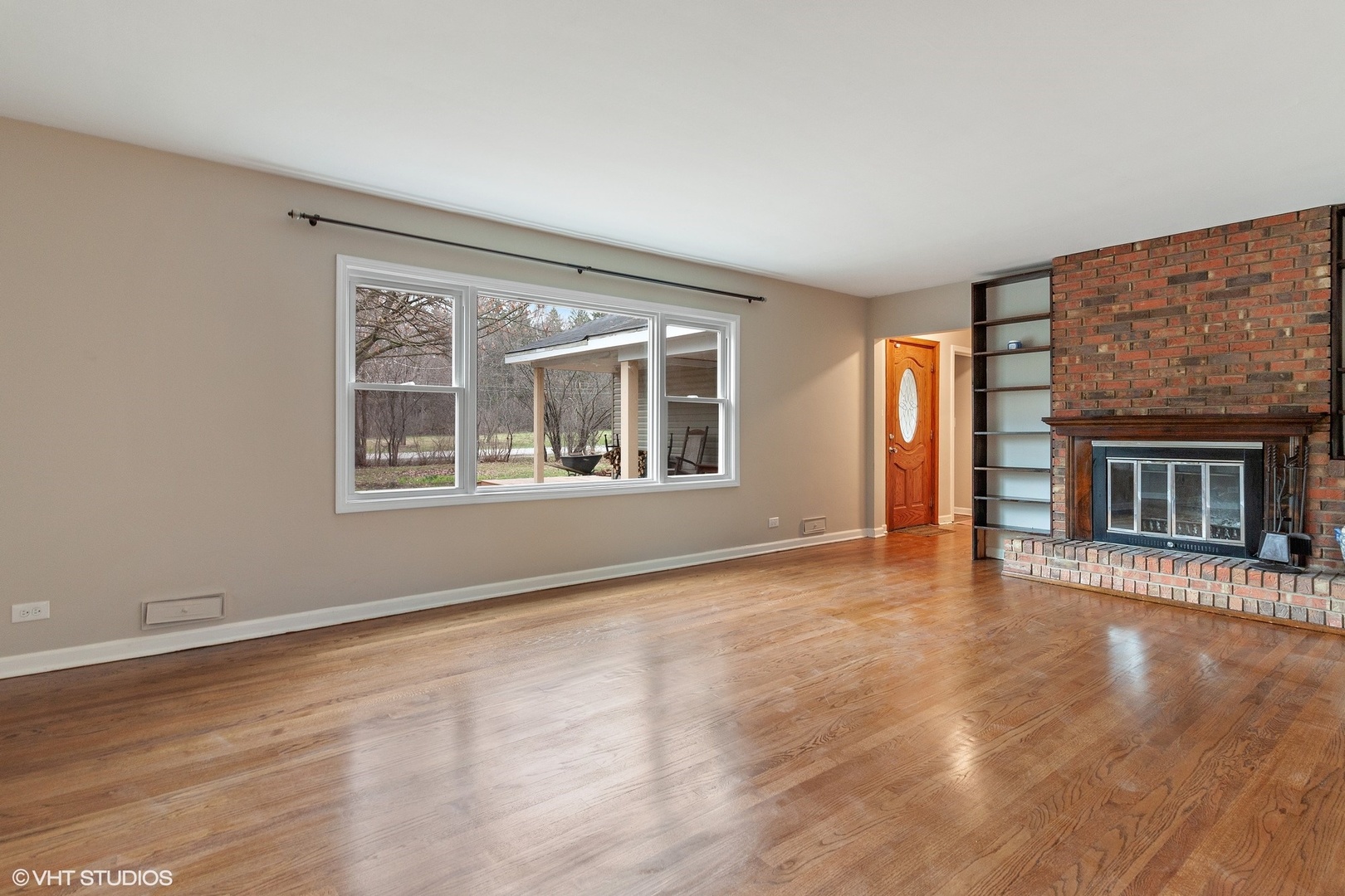 28W753 Roosevelt Road West Chicago, IL 60185 - Photo 2 of 17 a view of an empty room with wooden floor and a window