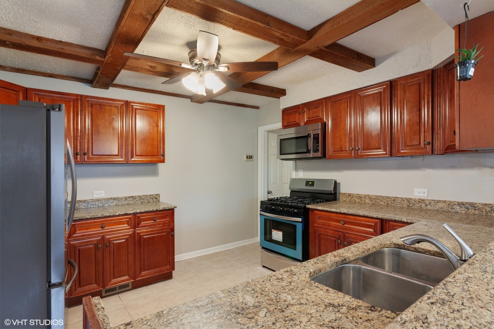 28W753 Roosevelt Road West Chicago, IL 60185 - Photo 4 of 17 a kitchen with stainless steel appliances granite countertop a sink stove and cabinets