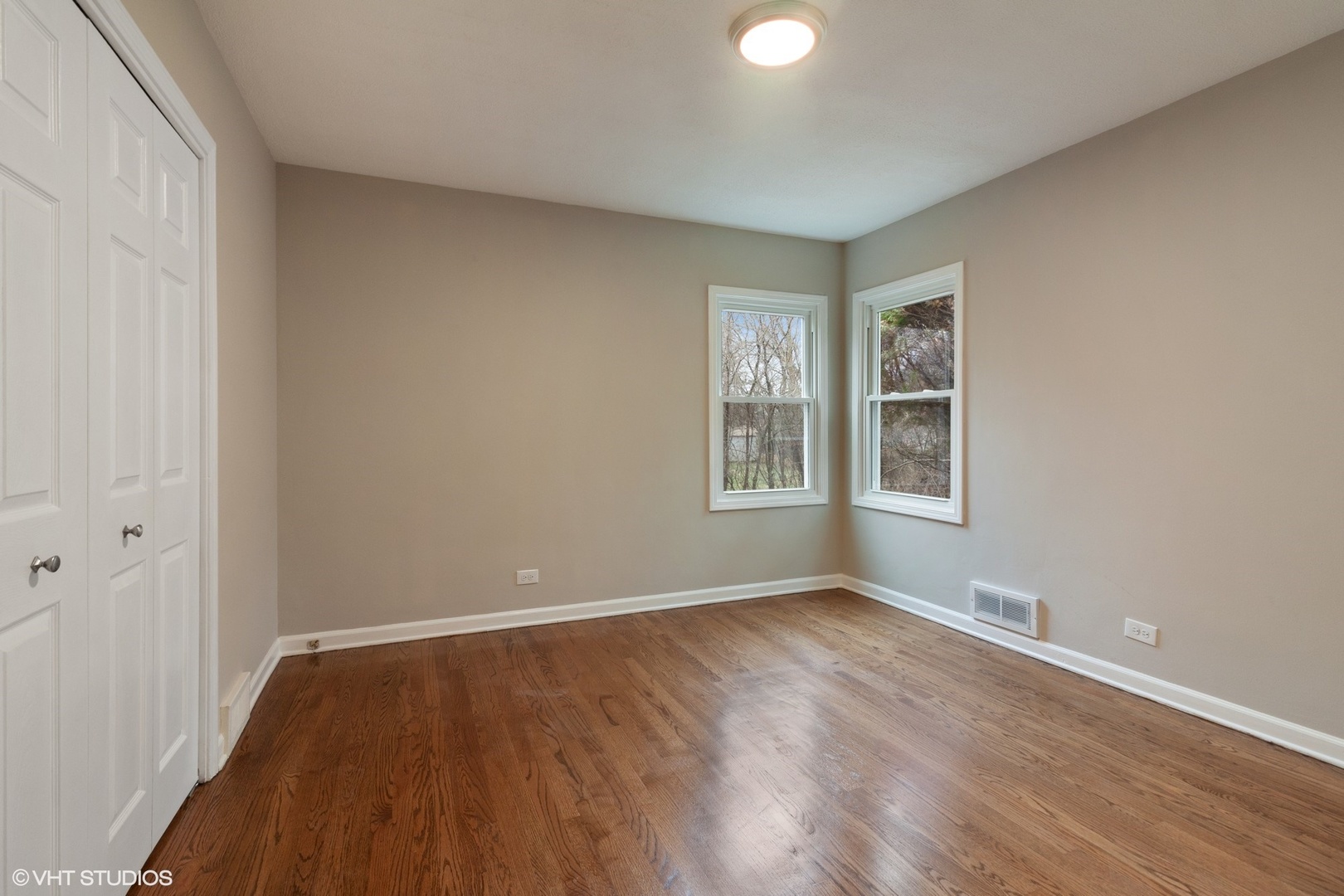28W753 Roosevelt Road West Chicago, IL 60185 - Photo 9 of 17 wooden floor in an empty room with a window