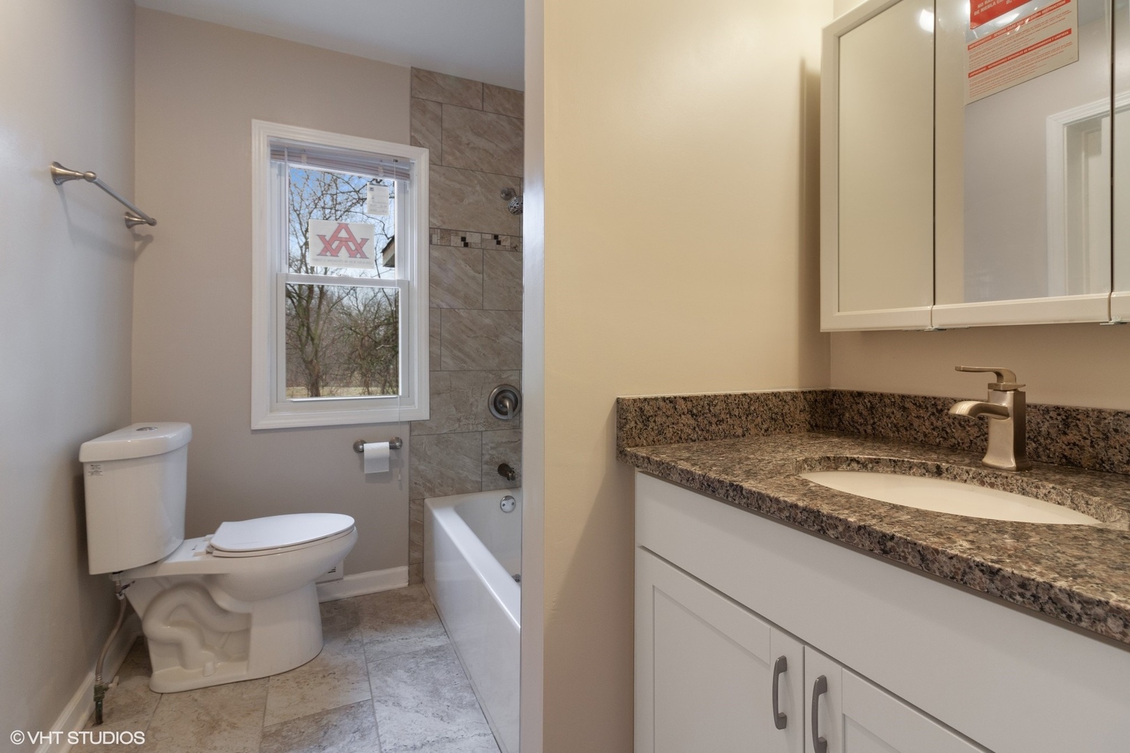 28W753 Roosevelt Road West Chicago, IL 60185 - Photo 10 of 17 a bathroom with a granite countertop sink and a toilet