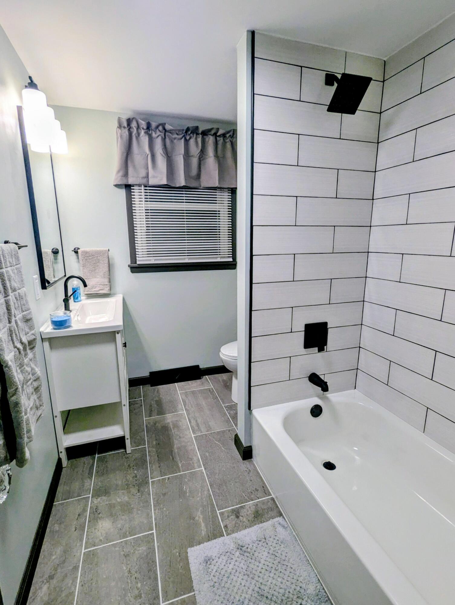 521 Ryan Road Hebron, IN 46341 - Photo 19 of 25 a bathroom with a bathtub sink and mirror