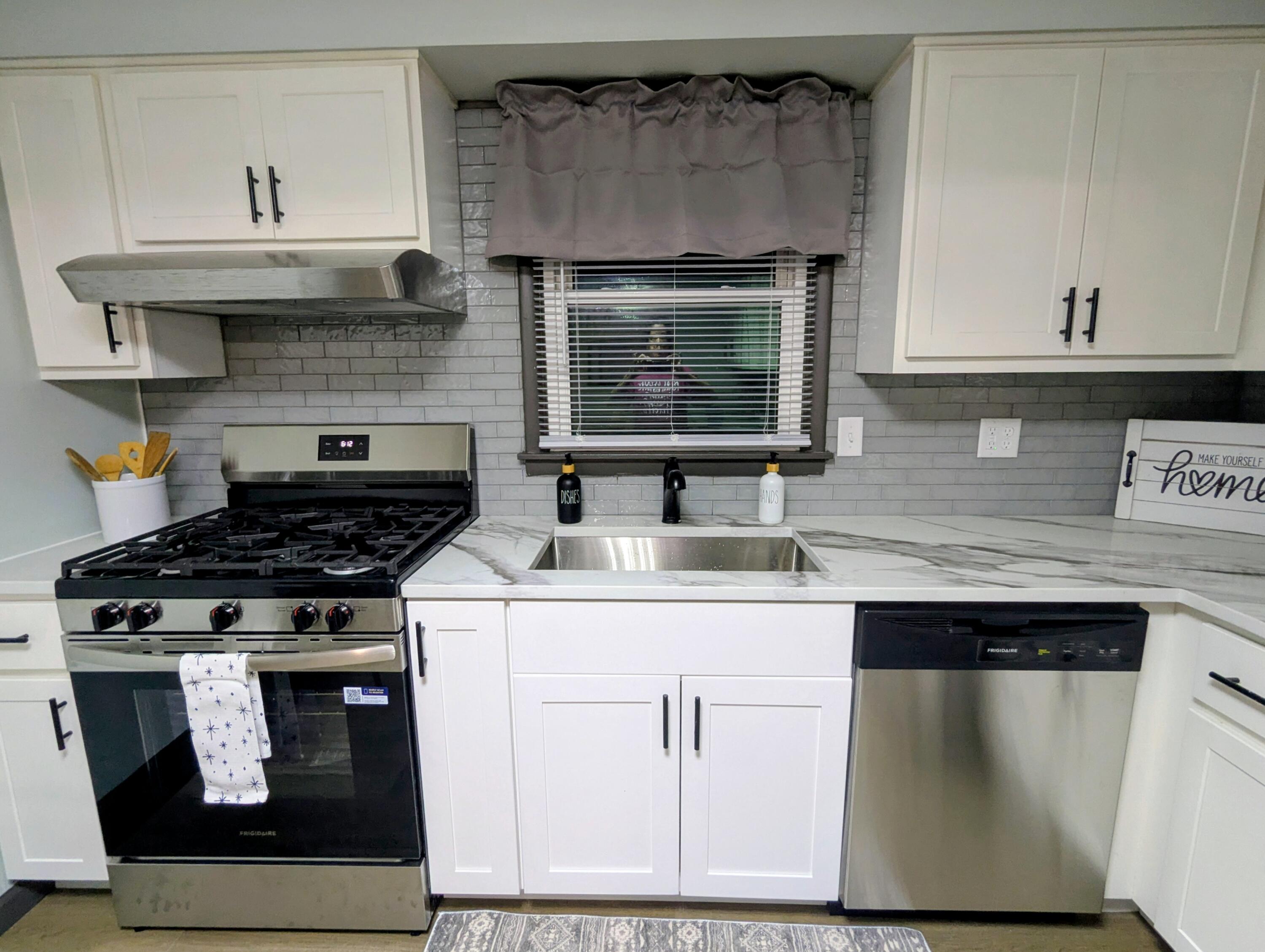 521 Ryan Road Hebron, IN 46341 - Photo 7 of 25 a kitchen with stainless steel appliances granite countertop a stove and a microwave