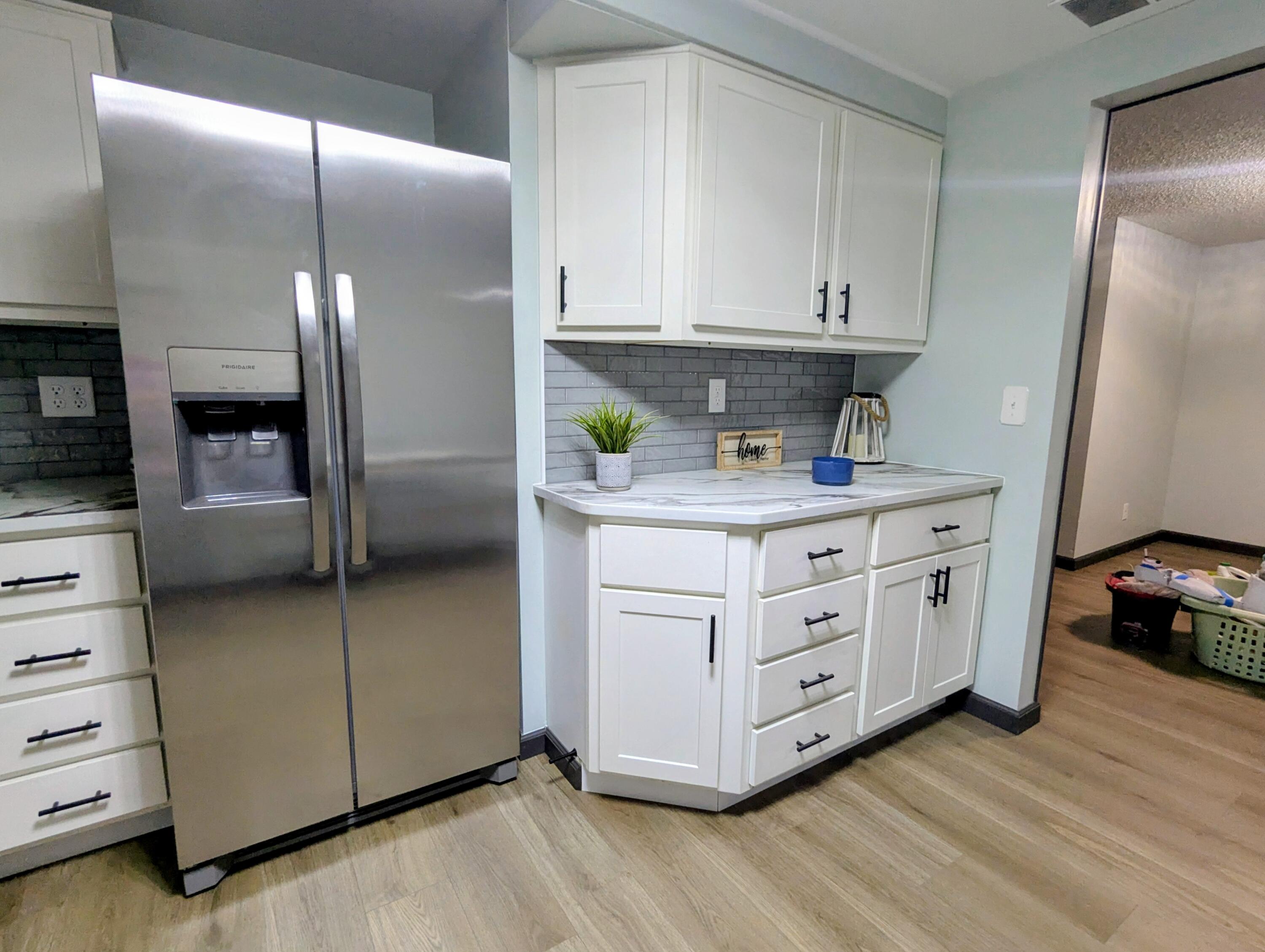 521 Ryan Road Hebron, IN 46341 - Photo 8 of 25 a kitchen with stainless steel appliances granite countertop a sink a stove and a refrigerator