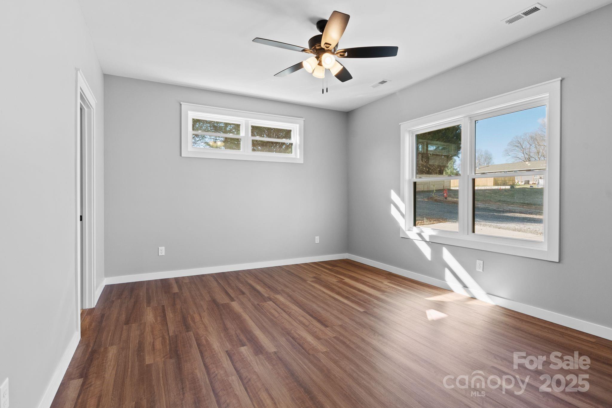 80 Peyton Elaine Road Clyde, NC 28721 - Photo 13 of 28 a view of an empty room with wooden floor and a window