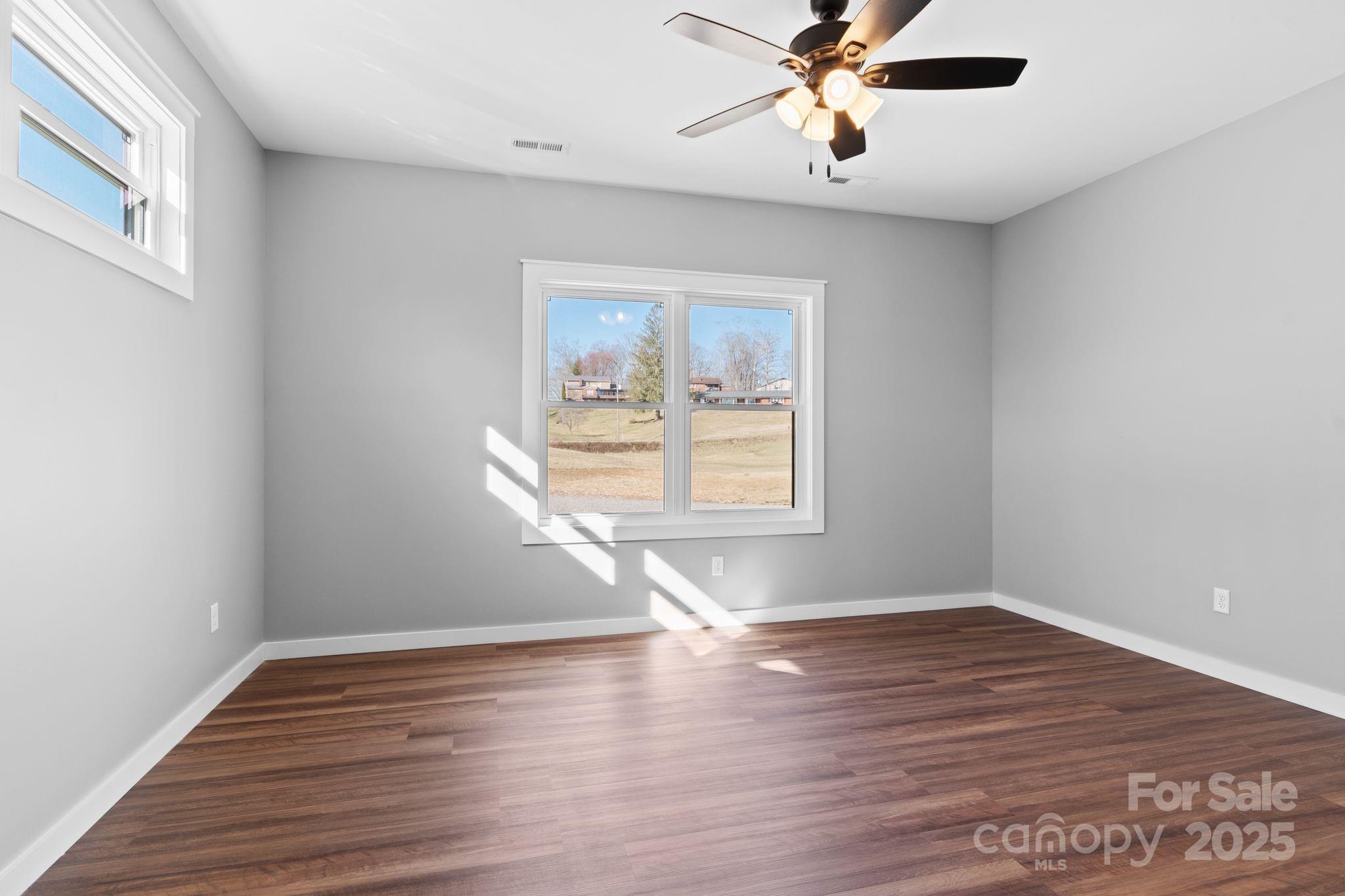 80 Peyton Elaine Road Clyde, NC 28721 - Photo 14 of 28 a view of empty room with wooden floor and fan