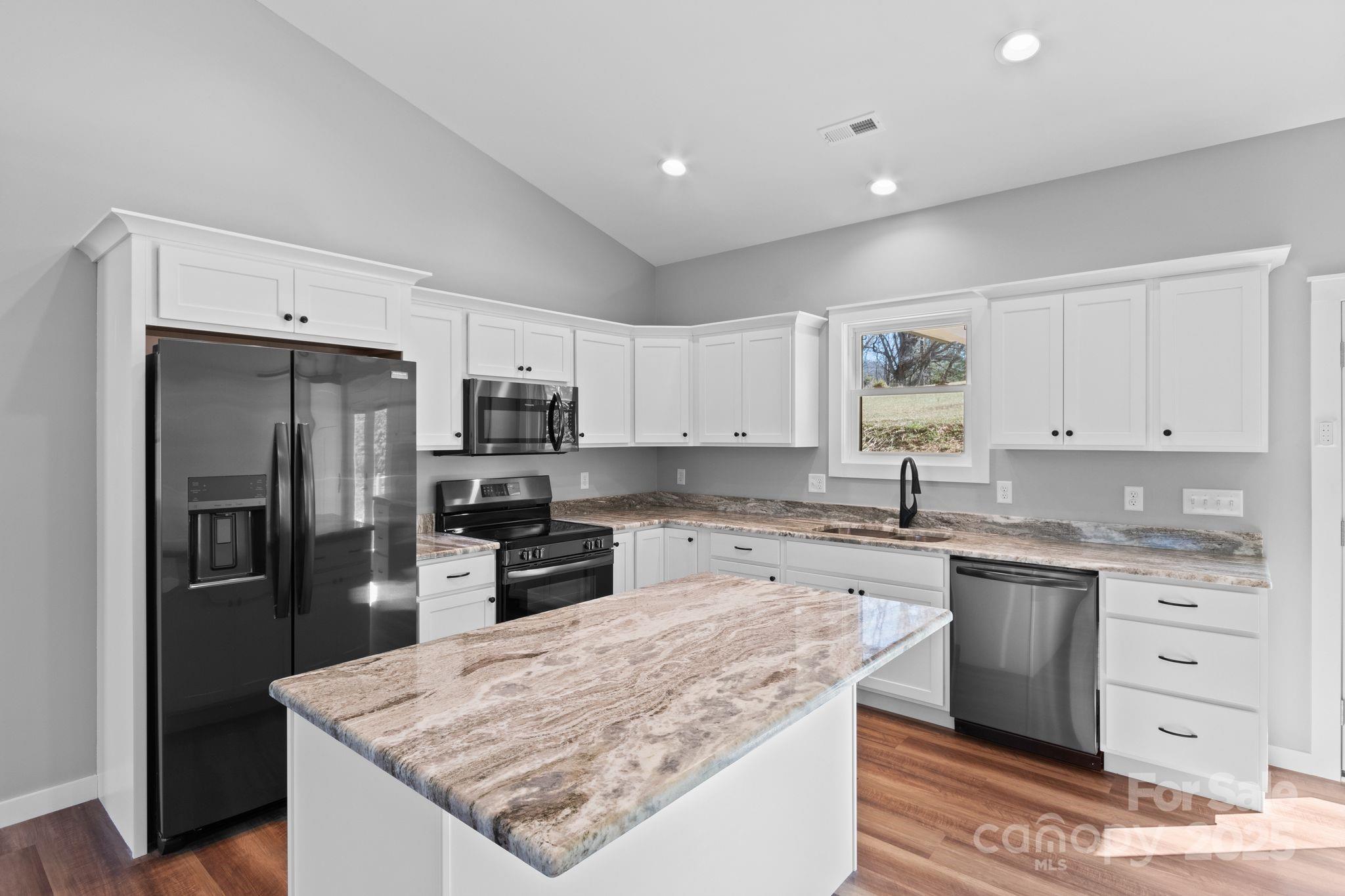 80 Peyton Elaine Road Clyde, NC 28721 - Photo 2 of 28 a kitchen with granite countertop kitchen island cabinets and stainless steel appliances