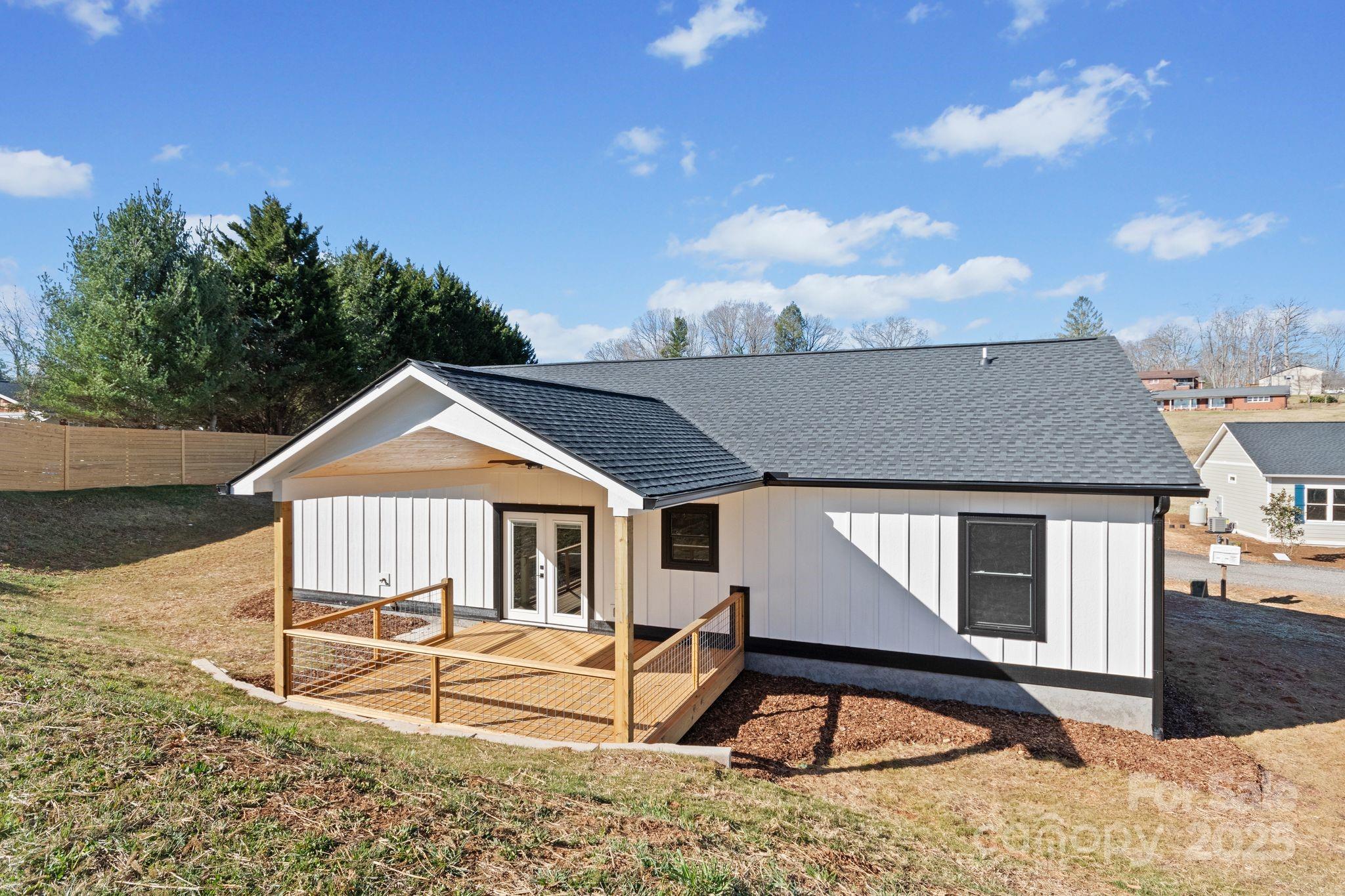 80 Peyton Elaine Road Clyde, NC 28721 - Photo 26 of 28 a view of a house with backyard and sitting area