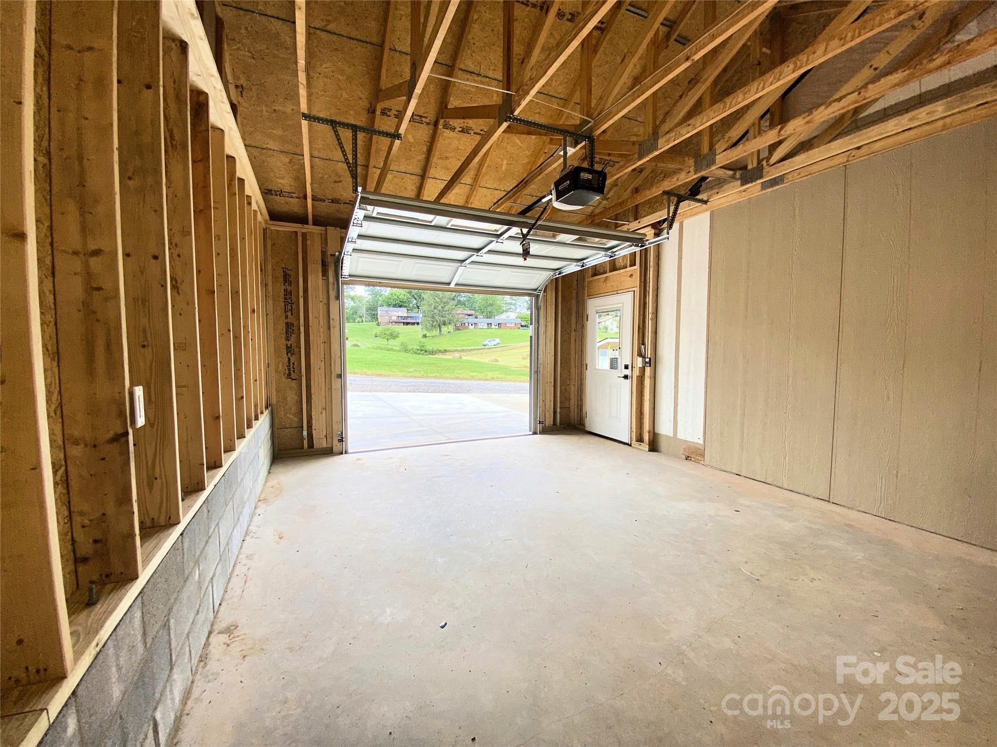 80 Peyton Elaine Road Clyde, NC 28721 - Photo 28 of 28 a view of empty room with wooden walls and sliding door