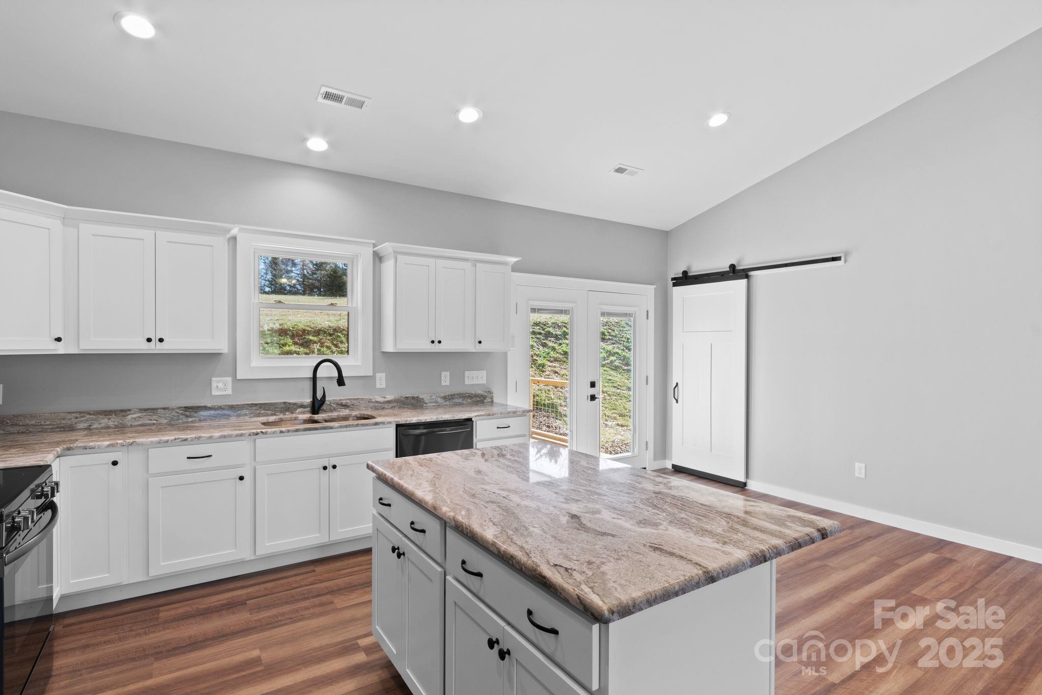 80 Peyton Elaine Road Clyde, NC 28721 - Photo 8 of 28 a kitchen with a sink stove and cabinets