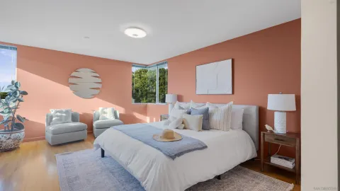 a large bed sitting in a bedroom next to a window