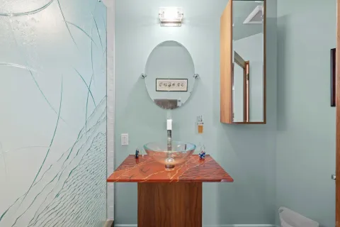 a bathroom with a sink vanity and a mirror