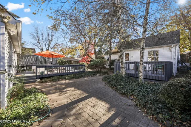a bedroom with a bed and a flat tv screen on wall