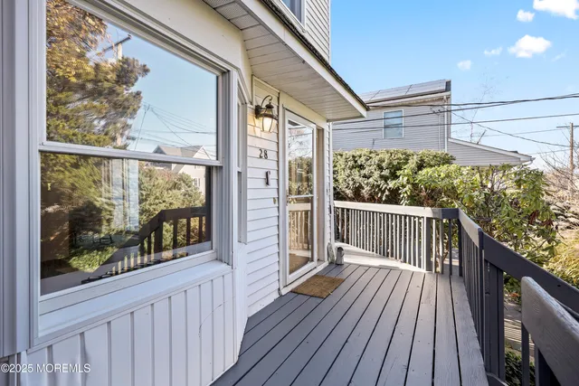 a view of a balcony with wooden floor