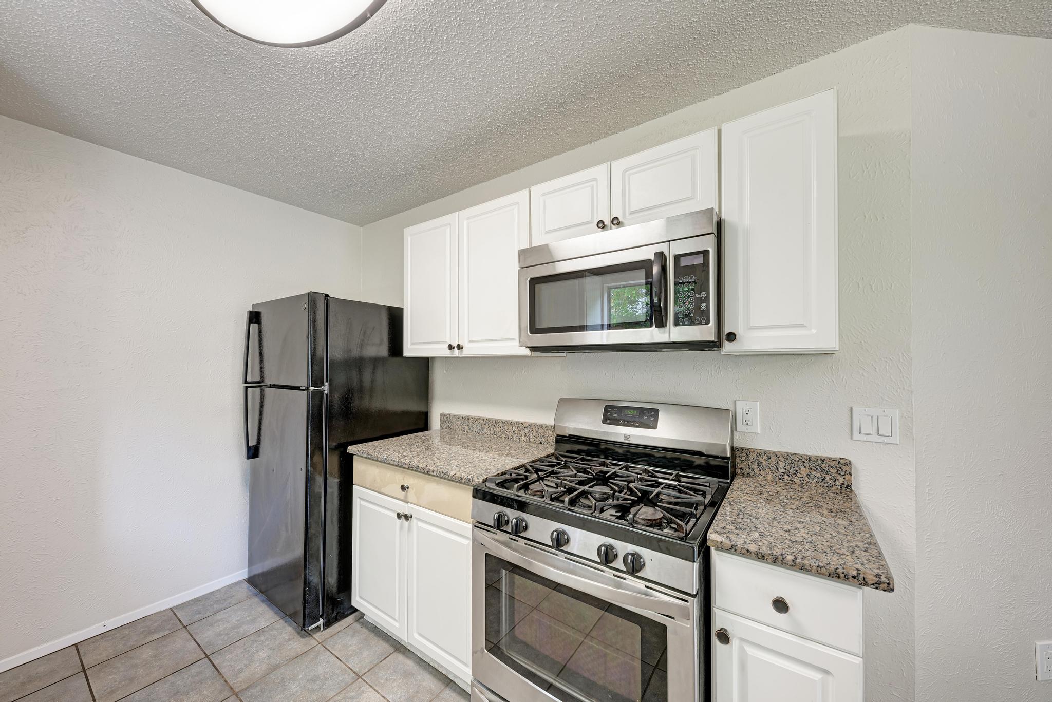 12108 Carnforth Drive Austin, TX 78753 - Photo 17 of 33 a kitchen with stainless steel appliances a refrigerator stove and microwave