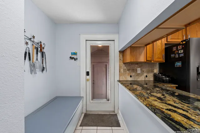 a kitchen with a refrigerator and a stove
