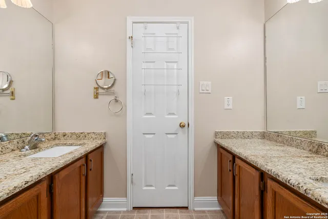 an empty room with wooden floor ceiling fan and windows