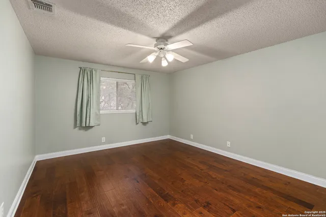 a view of an empty room and wooden floor