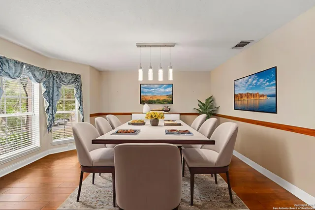 a view of a dining room with furniture wooden floor and chandelier