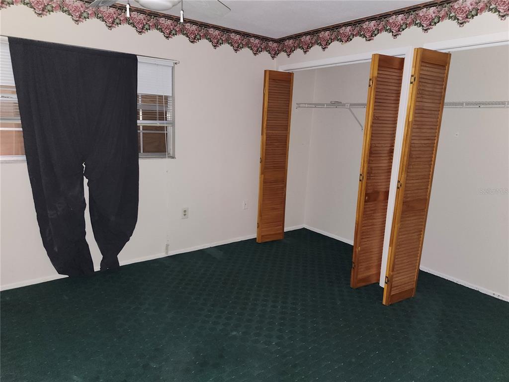 4060 Sail Drive New Port Richey, FL 34652 - Photo 15 of 20 a view of an empty room with wooden floor and a window