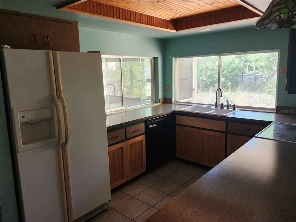 4060 Sail Drive New Port Richey, FL 34652 - Photo 5 of 20 a kitchen with stainless steel appliances granite countertop a refrigerator and a sink