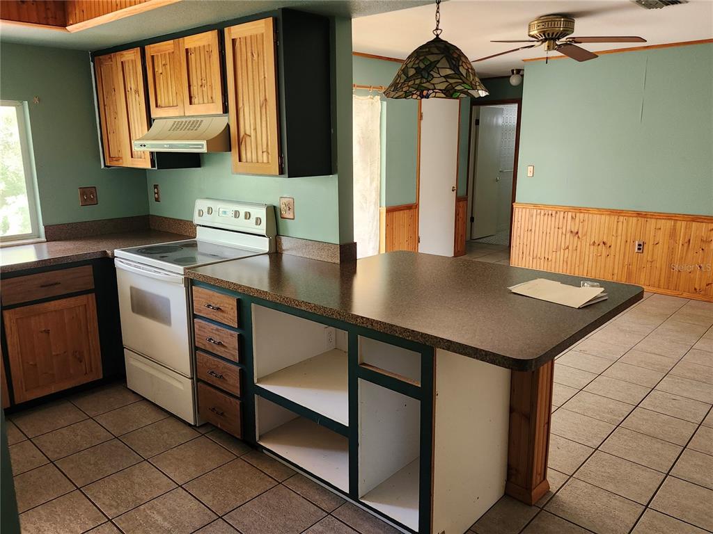 4060 Sail Drive New Port Richey, FL 34652 - Photo 7 of 20 a kitchen with a sink cabinets and wooden floor