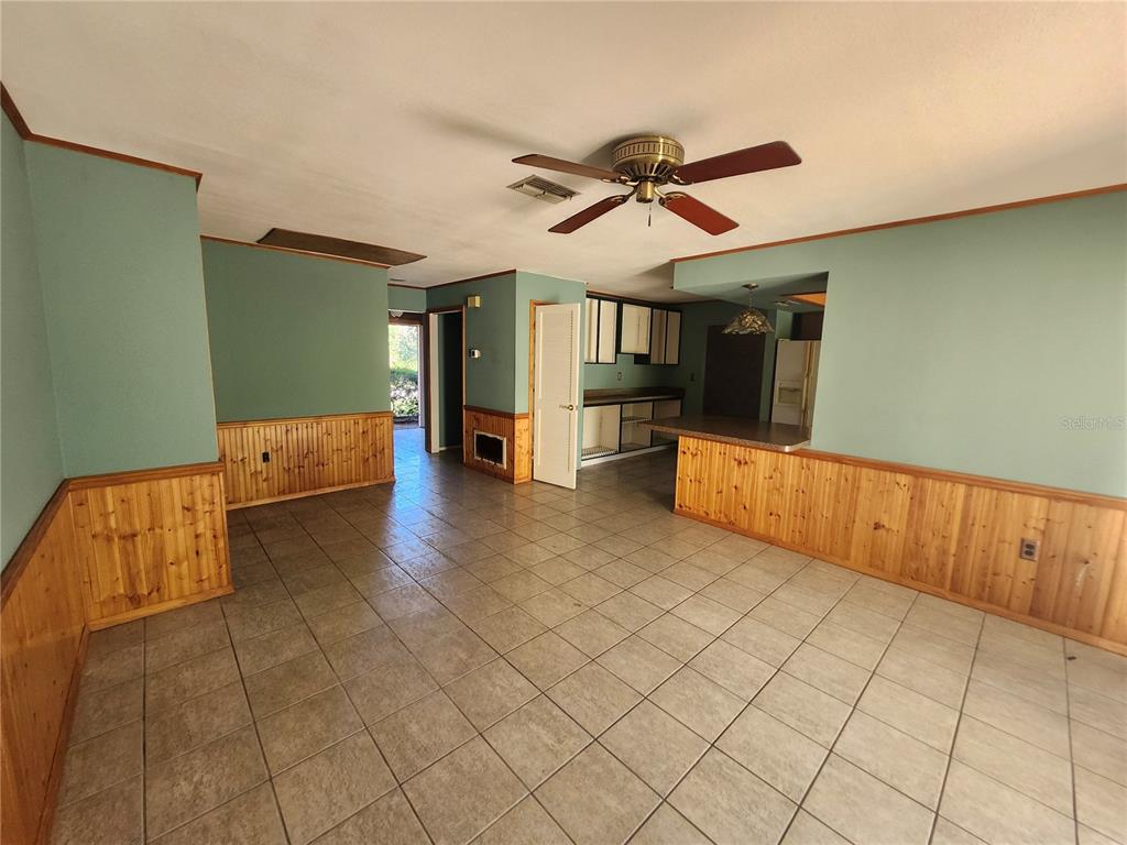 4060 Sail Drive New Port Richey, FL 34652 - Photo 9 of 20 a view of hallway with furniture and a ceiling fan