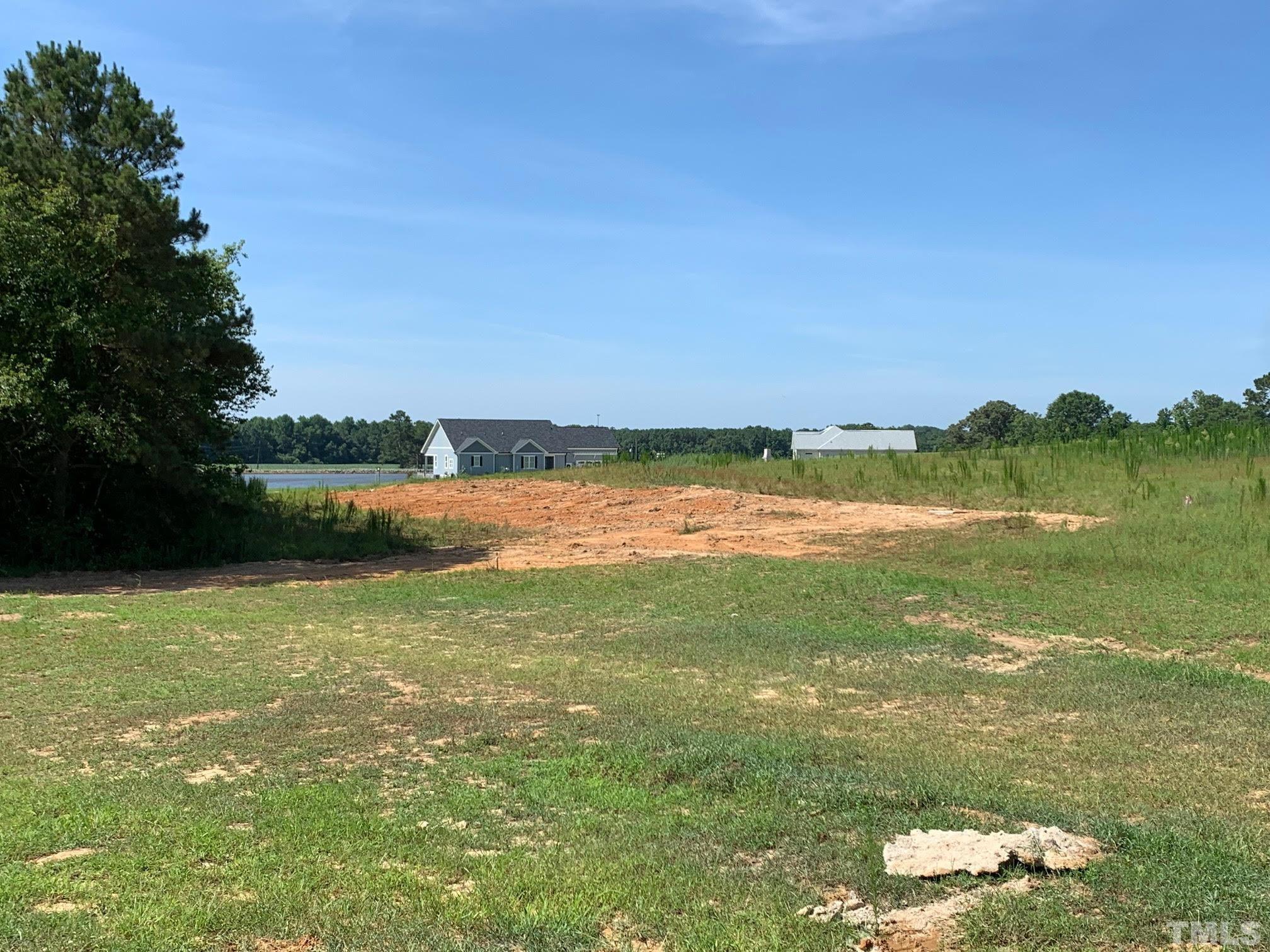 88 Bodacious Lane Benson, NC 27504 - Photo 12 of 13 a view of a lake with houses in the background