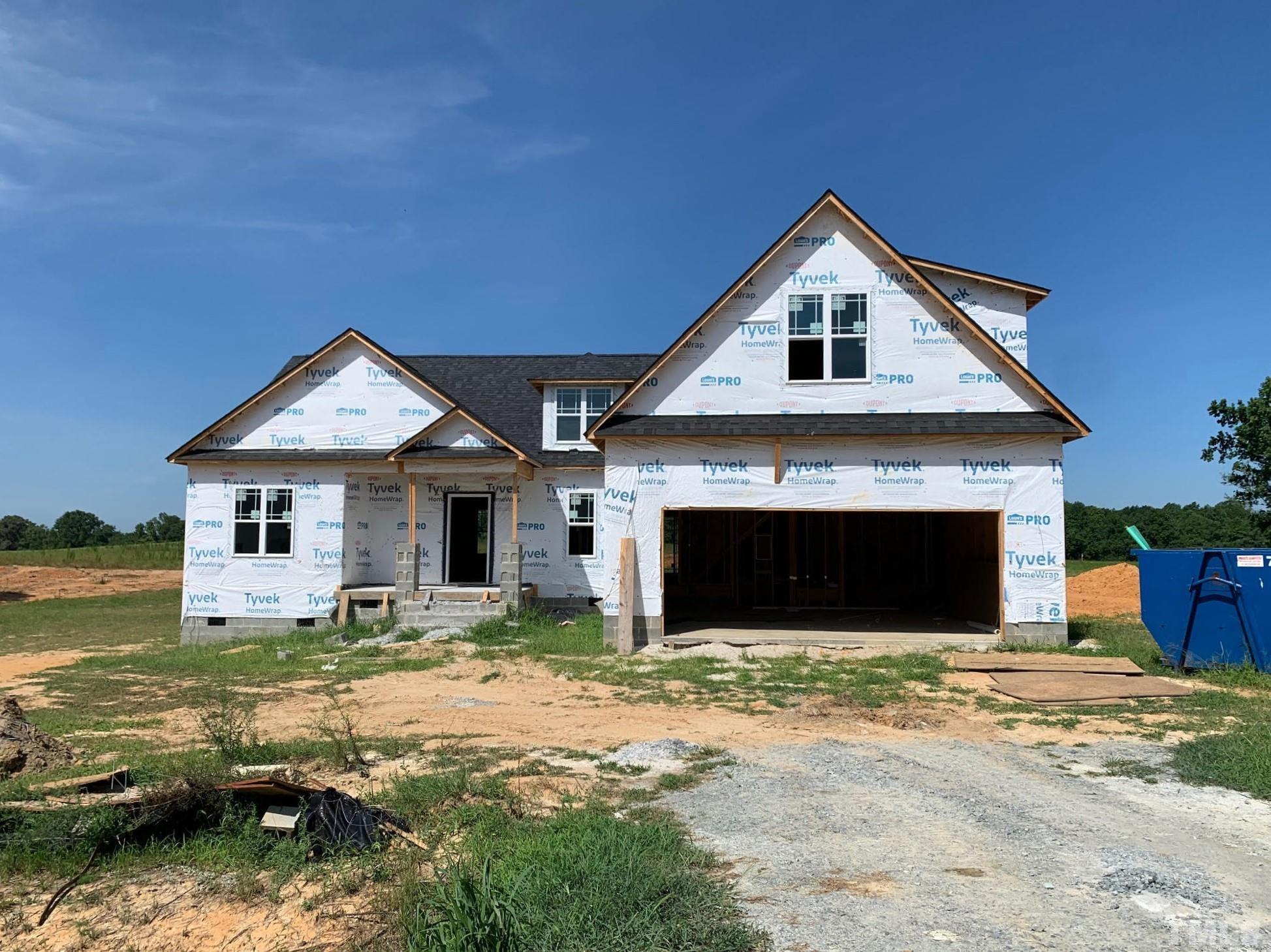 88 Bodacious Lane Benson, NC 27504 - Photo 2 of 13 a front view of a house with a yard and garage