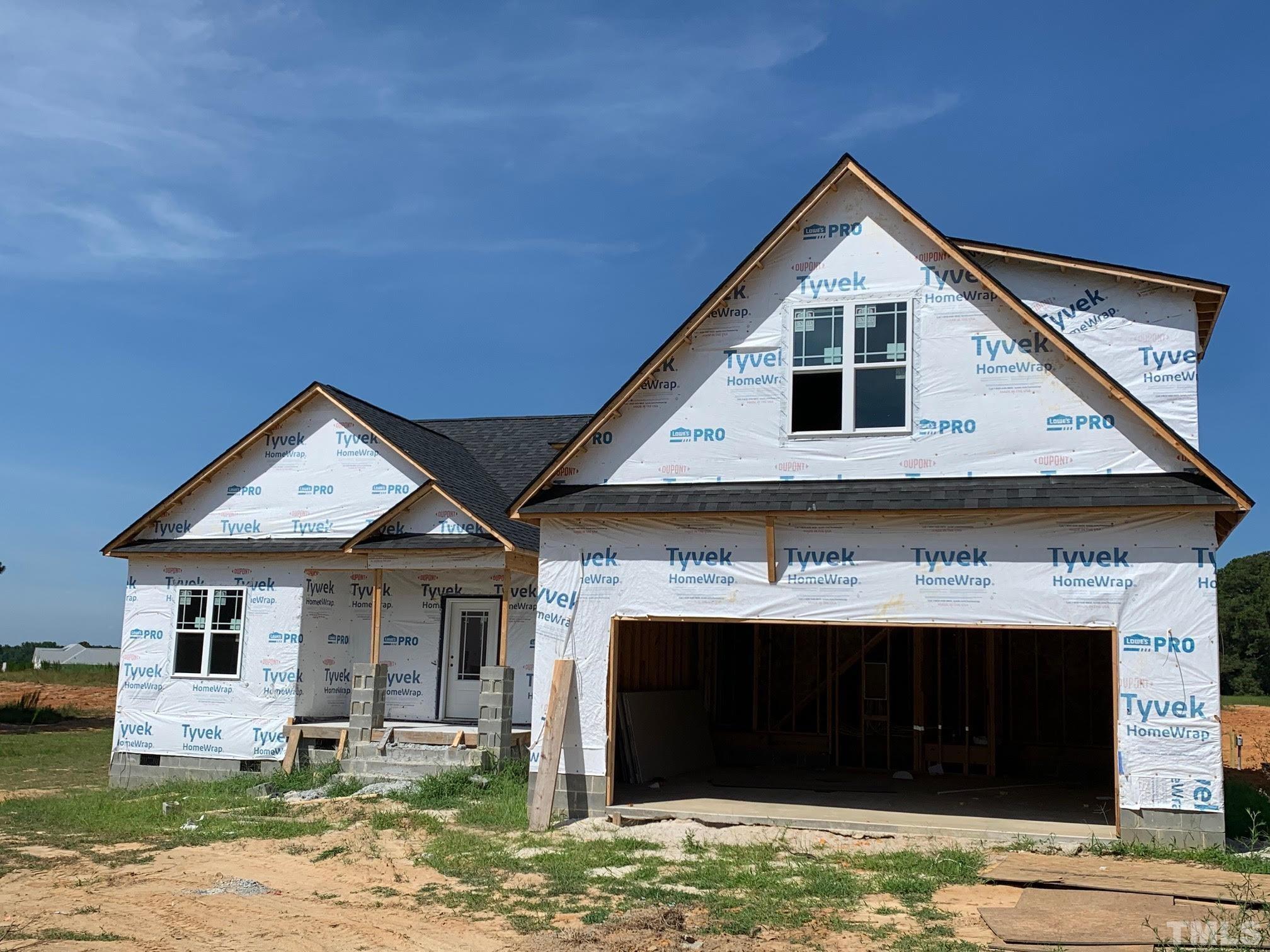 88 Bodacious Lane Benson, NC 27504 - Photo 4 of 13 a front view of a house with garden
