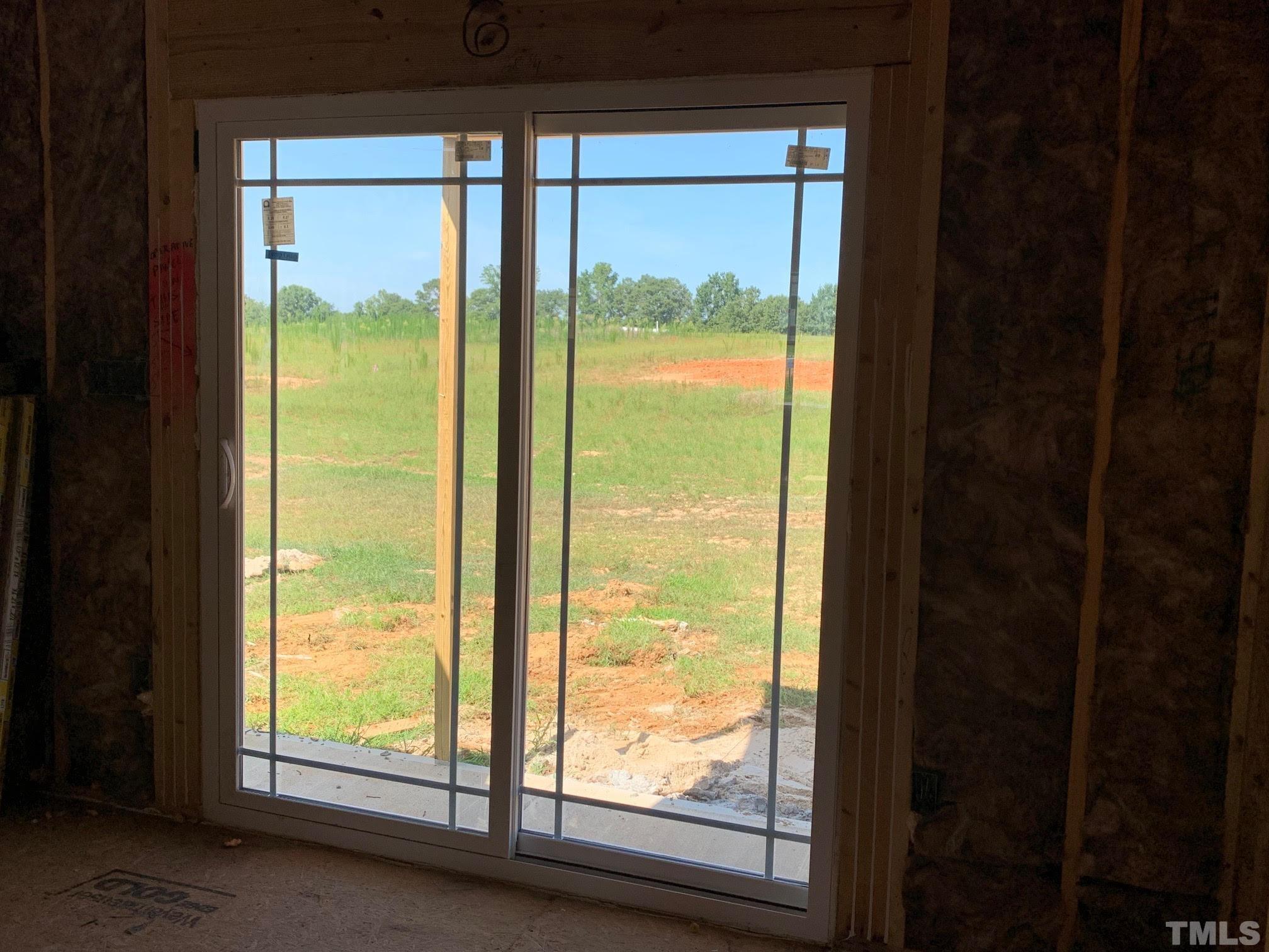 88 Bodacious Lane Benson, NC 27504 - Photo 8 of 13 a view of an empty room and window