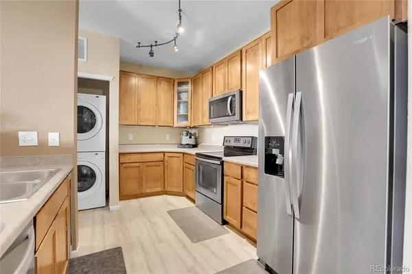 a kitchen with a refrigerator a stove top oven a sink and dishwasher