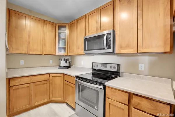 a kitchen with stainless steel appliances granite countertop a sink a stove and microwave