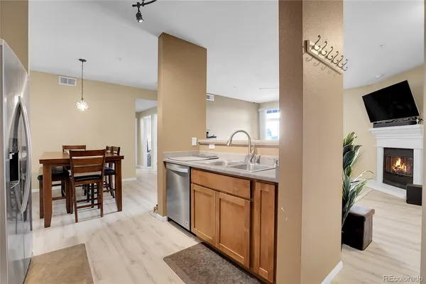 a kitchen with kitchen island a sink dining table and chairs
