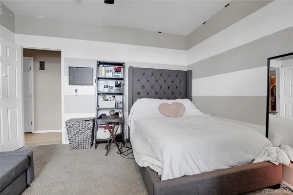 a bedroom with a bed and a bookshelf