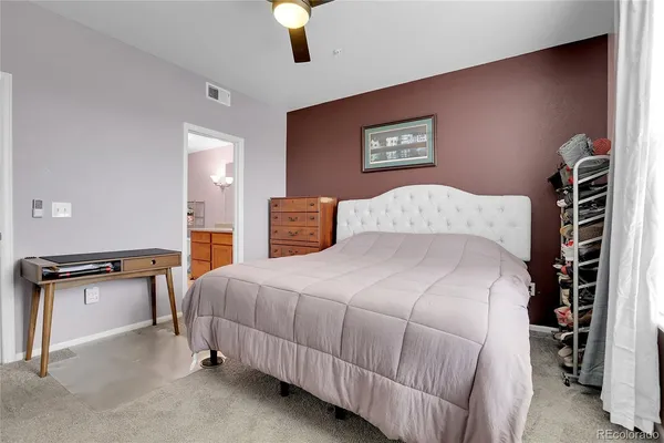 a bedroom with a bed and a lamp