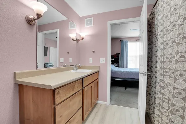 a en suite bathroom with a sink and a mirror