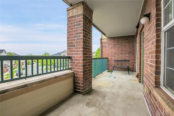 a view of a balcony with wooden fence