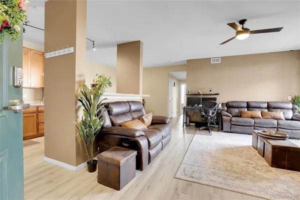 a living room with furniture and a potted plant