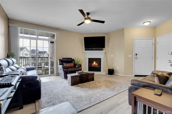 a living room with furniture a fireplace and a flat screen tv