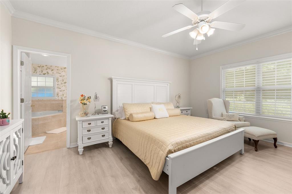 7418 White Oaks Road Alachua, FL 32615 - Photo 15 of 46 a bedroom with a bed and a chandelier fan