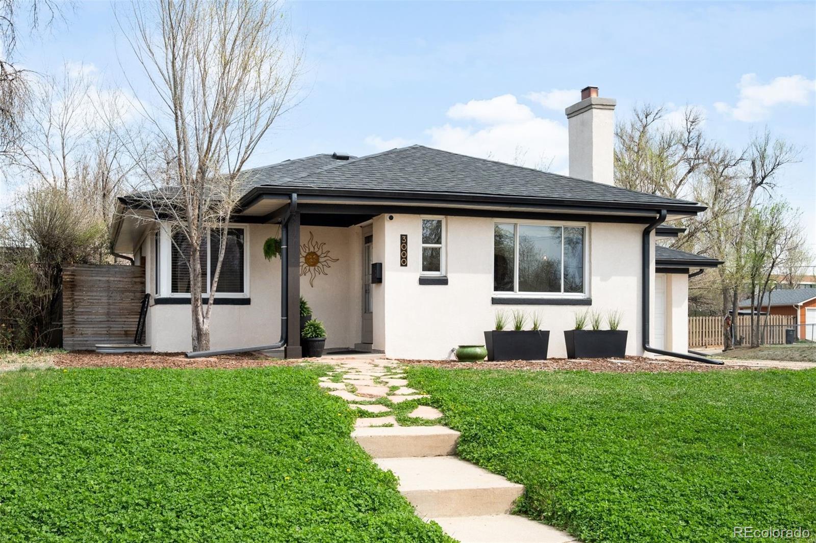 3000 Ivy Street Denver, CO 80207 - Photo 1 of 26 a front view of a house with a yard